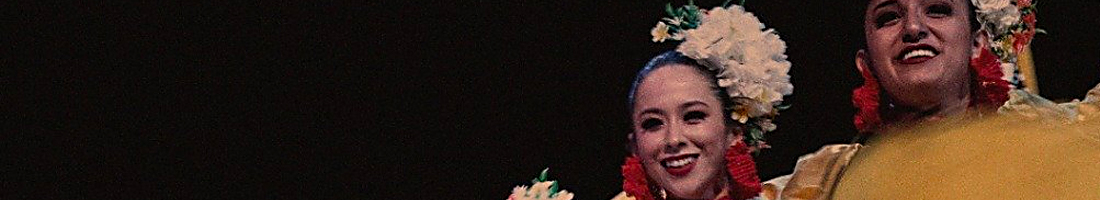 Foto donde se ve el rostro sonriente de dos mujeres bailarinas de cumbia