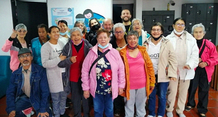 Grupo de adultas mayores en la biblioteca posando para la foto.
